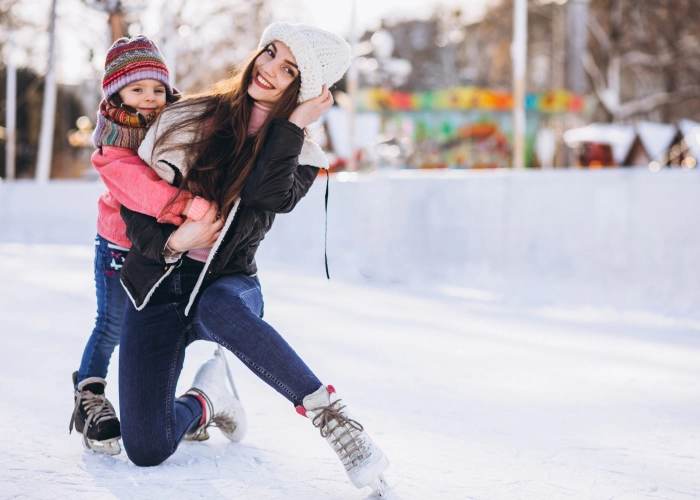mother-with-daughter-teaching-ice-skating-rink